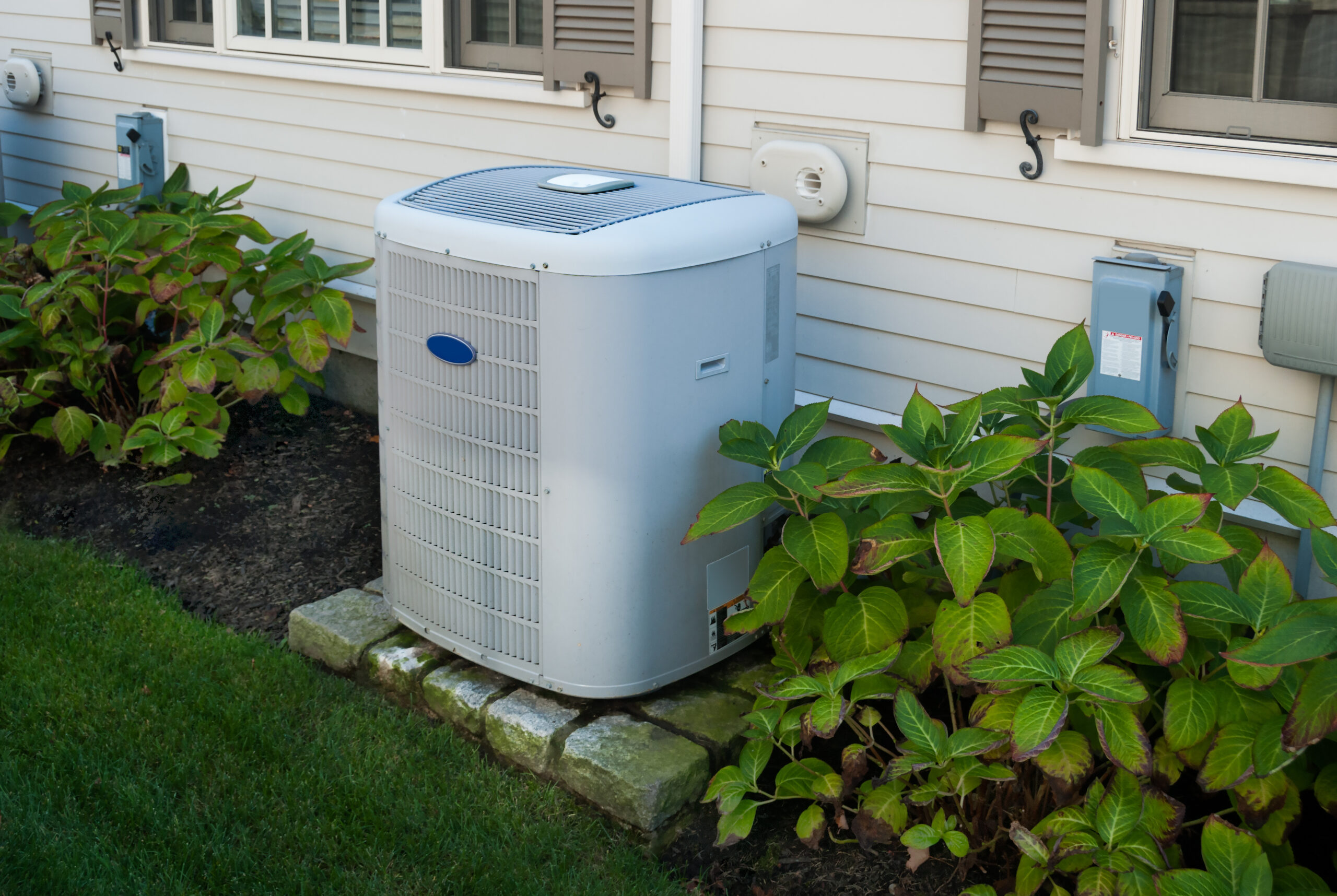 Modern heat pump installed outside a Utah home