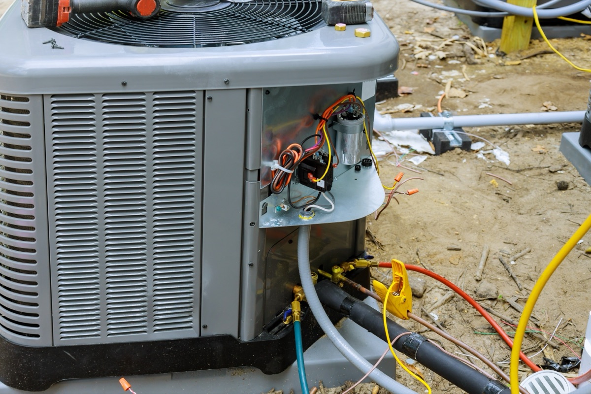 HVAC technician servicing a central air conditioning unit in Utah