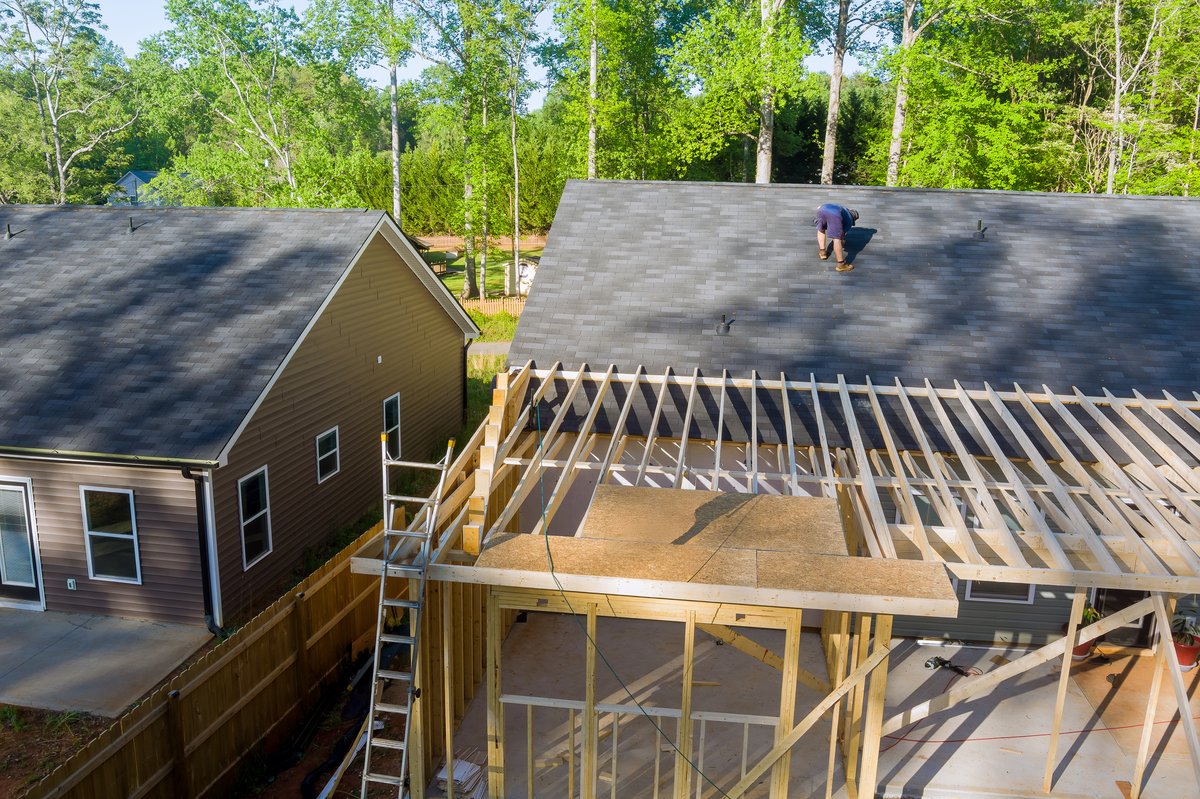 Home room addition under construction — framing and roof work on a residential addition in northern Utah